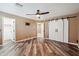 Bedroom featuring stylish barn doors, wood-look flooring, and a contemporary ceiling fan with light at 2161 E Flintlock Way, Chandler, AZ 85286