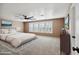 Large, bright bedroom with carpet, neutral paint, large windows and a modern ceiling fan at 2161 E Flintlock Way, Chandler, AZ 85286