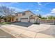 A beautiful home with a spacious driveway and an attached three-car garage at 2161 E Flintlock Way, Chandler, AZ 85286
