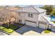 Attractive two story home with manicured lawn, three car garage, and a backyard pool at 2161 E Flintlock Way, Chandler, AZ 85286