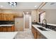 Kitchen featuring quartz countertops, custom cabinets, and stainless steel appliances at 2161 E Flintlock Way, Chandler, AZ 85286