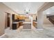 Open-concept kitchen with wood cabinets, tile backsplash, stainless steel appliances, and an island at 2161 E Flintlock Way, Chandler, AZ 85286