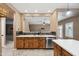 Charming kitchen with wood cabinets, stainless steel dishwasher, tile backsplash, and a modern island at 2161 E Flintlock Way, Chandler, AZ 85286