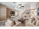 Spacious living room featuring neutral paint, modern fan, and an open concept to the second floor at 2161 E Flintlock Way, Chandler, AZ 85286
