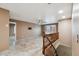 Open living area with neutral walls, tiled flooring, ceiling fan, and staircase to the second level at 2161 E Flintlock Way, Chandler, AZ 85286