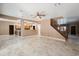 Bright open living space featuring tile flooring, wood staircase, and an open kitchen layout at 2161 E Flintlock Way, Chandler, AZ 85286