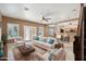 Bright living room area features a large couch, plush chairs, stylish rug and tons of natural light at 2161 E Flintlock Way, Chandler, AZ 85286
