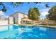 Backyard pool with pristine water and lawn, shaded by trees and tiki umbrellas at 2161 E Flintlock Way, Chandler, AZ 85286