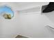 Walk-in closet with a window, offering natural light and ample storage with clothing rods at 2161 E Flintlock Way, Chandler, AZ 85286