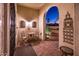 Charming courtyard entry with wrought iron gate and brick flooring at 21935 N San Ramon Dr, Sun City West, AZ 85375