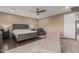 Main bedroom with tufted headboard and sitting area at 2213 W Twain Dr, Anthem, AZ 85086