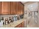 Home wet bar with granite countertop, wine rack, and ample storage at 2213 W Twain Dr, Anthem, AZ 85086