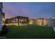 Landscaped backyard with pergola, built-in fire pit, and artificial turf at 23311 N 95Th Dr, Peoria, AZ 85383