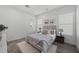 Light and airy bedroom with a gray upholstered bed and wood nightstands at 23311 N 95Th Dr, Peoria, AZ 85383