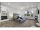 Spacious main bedroom with large gray upholstered bed and chandelier at 23311 N 95Th Dr, Peoria, AZ 85383