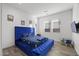 Spacious bedroom with a plush velvet bed and playful decor at 23311 N 95Th Dr, Peoria, AZ 85383