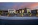 Stunning curb appeal! This modern home features a two-tone exterior and landscape lighting at 23311 N 95Th Dr, Peoria, AZ 85383