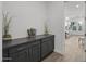 Hallway with dark gray cabinets and view into living room at 23311 N 95Th Dr, Peoria, AZ 85383