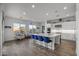 Modern kitchen with large island, white cabinets, and granite countertops at 23311 N 95Th Dr, Peoria, AZ 85383
