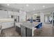 Modern kitchen boasts a farmhouse sink, stainless steel appliances, and an eat-in island at 23311 N 95Th Dr, Peoria, AZ 85383