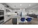 Open concept kitchen features a large island with seating and views into the living room at 23311 N 95Th Dr, Peoria, AZ 85383