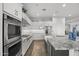 Bright kitchen with white cabinets, stainless steel appliances, and granite countertops at 23311 N 95Th Dr, Peoria, AZ 85383