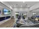 Open concept living room showcasing a fireplace, large TV, and comfortable seating at 23311 N 95Th Dr, Peoria, AZ 85383