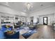 Open living area with large sectional sofa and views into kitchen and entryway at 23311 N 95Th Dr, Peoria, AZ 85383