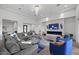 Open concept living room with sectional sofa, fireplace, and access to backyard at 23311 N 95Th Dr, Peoria, AZ 85383