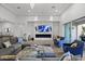 Modern living room with sectional sofa, fireplace, and blue accent chairs at 23311 N 95Th Dr, Peoria, AZ 85383