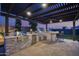 Outdoor kitchen with grill, refrigerator, and stone countertops at 23311 N 95Th Dr, Peoria, AZ 85383