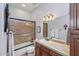 Updated bathroom with a shower/tub combo and stylish wood vanity at 351 N Cloverfield Cir, Litchfield Park, AZ 85340