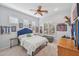 Bright bedroom with a queen bed, window seat, and decorative wall accents at 351 N Cloverfield Cir, Litchfield Park, AZ 85340