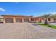 Three-car garage, Spanish-style home with landscaped grounds at 351 N Cloverfield Cir, Litchfield Park, AZ 85340