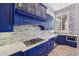 Modern kitchen with blue cabinets, white countertops, and stainless steel appliances at 351 N Cloverfield Cir, Litchfield Park, AZ 85340