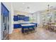 Bright kitchen featuring blue cabinets, an island, and a dining area at 351 N Cloverfield Cir, Litchfield Park, AZ 85340