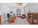 Home office with a large desk, comfortable seating, and built-in shelving at 351 N Cloverfield Cir, Litchfield Park, AZ 85340
