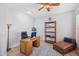 Bright home office with wood desk, comfortable chair, and open shelving at 351 N Cloverfield Cir, Litchfield Park, AZ 85340