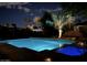 Inviting backyard pool and spa with lighting at night at 351 N Cloverfield Cir, Litchfield Park, AZ 85340