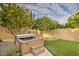 Relax in this backyard hot tub, nestled between two trees and artificial turf at 3680 W Ironwood Dr, Chandler, AZ 85226