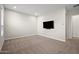 Bedroom with wall-mounted TV and neutral carpeting at 5126 E Village Dr, Scottsdale, AZ 85254