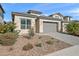 Modern house with gray garage door and stone facade at 5126 E Village Dr, Scottsdale, AZ 85254