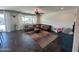 Comfortable living room with a leather sectional, stylish rug, and ample natural light from the window at 5306 N 188Th Ln, Litchfield Park, AZ 85340