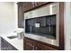 High-end Miele espresso machine built into cabinetry at 6213 W Saguaro Park Ln, Glendale, AZ 85310