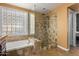 Spa-like bathroom with walk-in shower and soaking tub at 6872 W Linda Ln, Chandler, AZ 85226