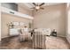 Living room with vaulted ceiling, two striped armchairs, and ceiling fan at 6872 W Linda Ln, Chandler, AZ 85226