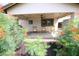 Relaxing patio area with rocking chairs, surrounded by lush greenery at 8114 E Clarendon Ave, Scottsdale, AZ 85251