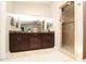 Bathroom with dark brown vanity and a walk-in shower at 8114 E Clarendon Ave, Scottsdale, AZ 85251