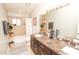 Clean bathroom with double vanity, bathtub, and shower at 8114 E Clarendon Ave, Scottsdale, AZ 85251