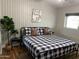 Guest bedroom with black and white bedding at 8114 E Clarendon Ave, Scottsdale, AZ 85251